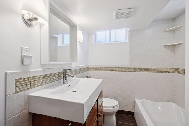168 1st St, Excelsior, MN 55331 - bathroom featuring tile walls, toilet, vanity, and wood finished floors