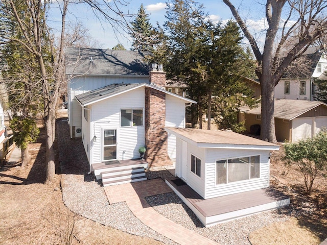 168 1st St, Excelsior, MN 55331 - back of property with a chimney and roof with shingles