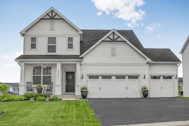 20555 Greenwood Ave, Lakeville, MN 55044 - view of front of house featuring asphalt driveway, a front yard, roof with shingles, and a porch