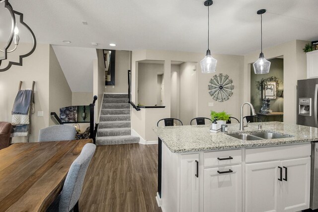 20555 Greenwood Ave, Lakeville, MN 55044 - kitchen featuring a sink, dark wood-type flooring, baseboards, a kitchen island with sink, and white cabinetry