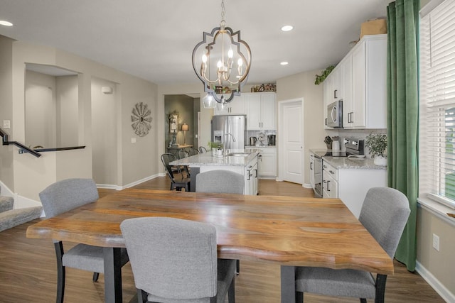 20555 Greenwood Ave, Lakeville, MN 55044 - dining area with a chandelier, baseboards, light wood-type flooring, and recessed lighting