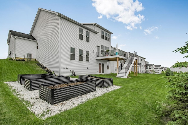 20555 Greenwood Ave, Lakeville, MN 55044 - back of house with a garden, a wooden deck, a yard, and stairs
