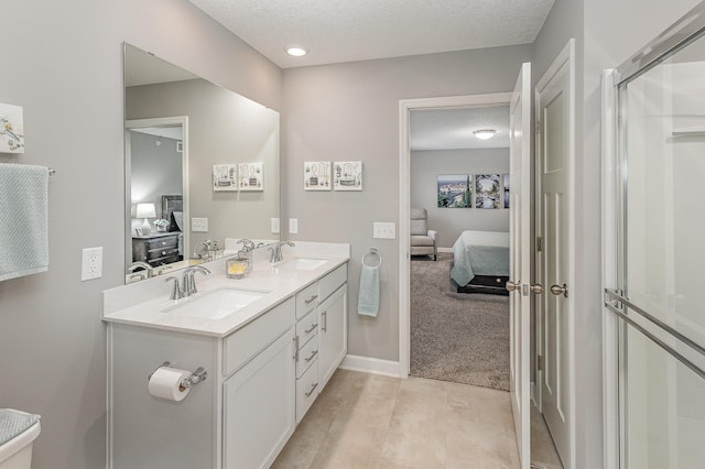 1259 Lower 143rd St E, Rosemount, MN 55068 - ensuite bathroom with double vanity, a textured ceiling, baseboards, and an enclosed shower