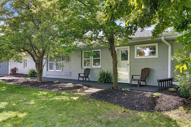 180 Saint Croix Trl N, Lakeland, MN 55043 - back of property with concrete block siding and a lawn