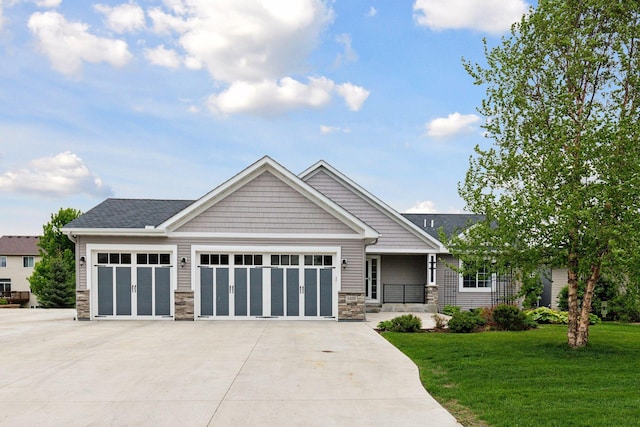 1429 10th Street Cir SE, New Prague, MN 56071 - craftsman house with stone siding, a front lawn, concrete driveway, an attached garage, and covered porch
