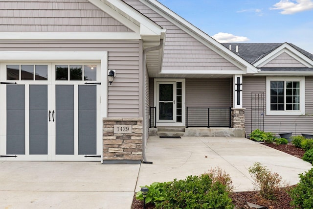 1429 10th Street Cir SE, New Prague, MN 56071 - view of exterior entry with stone siding and covered porch