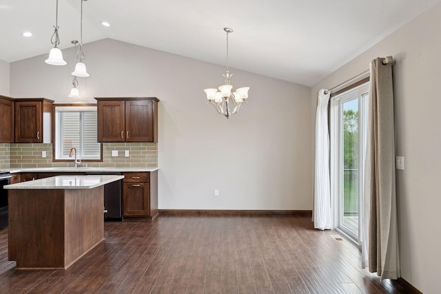 1429 10th Street Cir SE, New Prague, MN 56071 - kitchen featuring vaulted ceiling, dishwashing machine, a sink, light countertops, and decorative backsplash