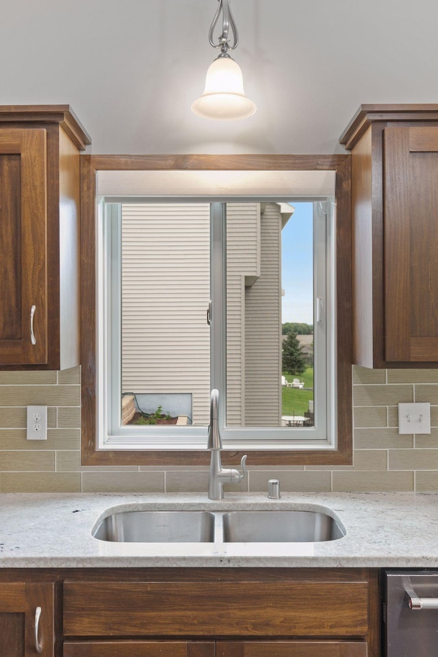 1429 10th Street Cir SE, New Prague, MN 56071 - kitchen featuring a sink, backsplash, pendant lighting, dishwasher, and light stone counters