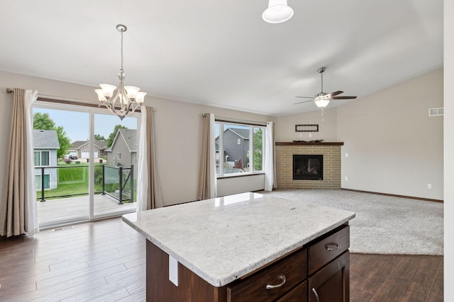 1429 10th Street Cir SE, New Prague, MN 56071 - kitchen with ceiling fan, light countertops, a chandelier, lofted ceiling, and decorative light fixtures