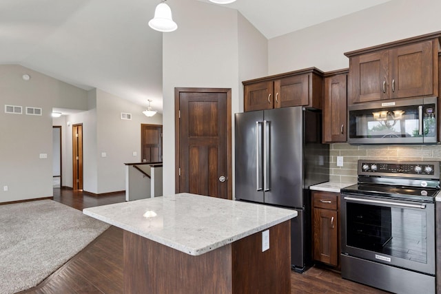 1429 10th Street Cir SE, New Prague, MN 56071 - kitchen featuring stainless steel appliances, vaulted ceiling, light stone counters, a center island, and decorative backsplash