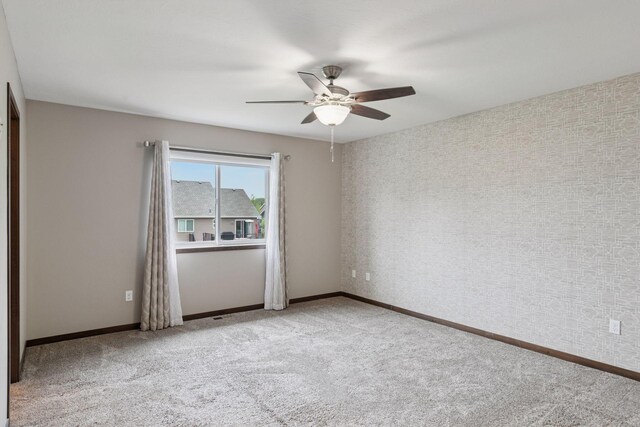 1429 10th Street Cir SE, New Prague, MN 56071 - empty room with ceiling fan, carpet, and baseboards