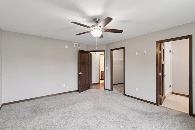 1429 10th Street Cir SE, New Prague, MN 56071 - unfurnished bedroom featuring light carpet, a spacious closet, baseboards, and a closet