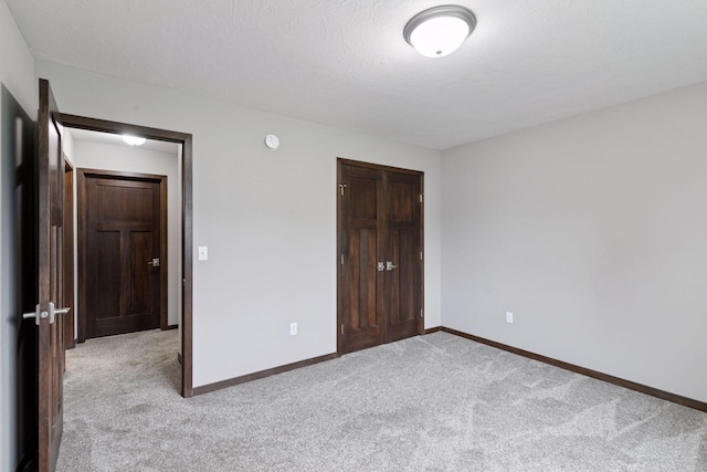 1429 10th Street Cir SE, New Prague, MN 56071 - unfurnished bedroom featuring light colored carpet, a closet, and baseboards