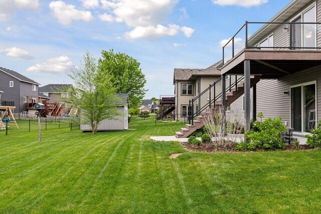 1429 10th Street Cir SE, New Prague, MN 56071 - view of yard with stairway, a residential view, and a wooden deck