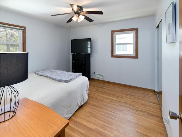 bedroom with light wood-type flooring and a ceiling fan
