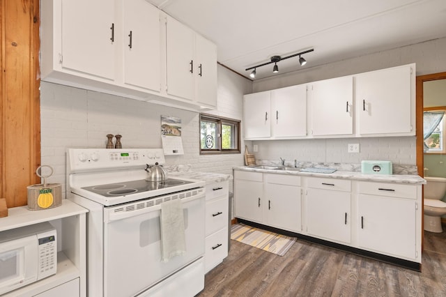 1605 White Ash Ln, Apple River Twp, WI 54810 - kitchen with white appliances, dark wood-style floors, light countertops, white cabinetry, and healthy amount of natural light