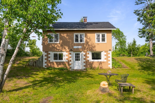 1605 White Ash Ln, Apple River Twp, WI 54810 - rear view of house with a lawn and a chimney