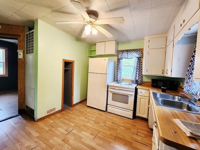 200 Jessie St, Marble, MN 55764 - kitchen featuring white appliances, a sink, wooden counters, light wood-style floors, and ceiling fan