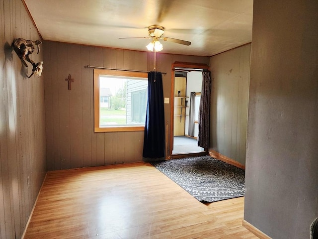 200 Jessie St, Marble, MN 55764 - empty room featuring wood finished floors, a ceiling fan, baseboards, and wooden walls