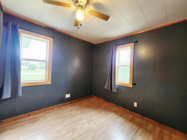 200 Jessie St, Marble, MN 55764 - unfurnished room with wood finished floors, ceiling fan, and crown molding