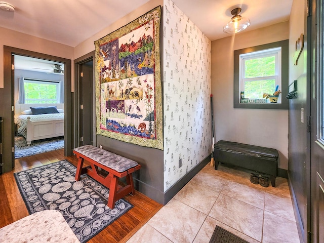 8586 Graves Lake Rd NE, Remer, MN 56672 - corridor with plenty of natural light, baseboards, wallpapered walls, and wood finished floors