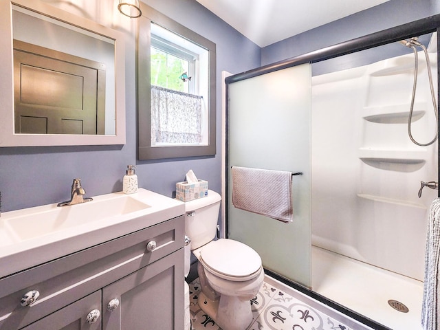 8586 Graves Lake Rd NE, Remer, MN 56672 - full bath with a stall shower, toilet, vanity, and tile patterned flooring