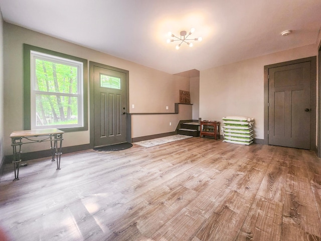 8586 Graves Lake Rd NE, Remer, MN 56672 - living room with light wood-style flooring, a chandelier, and baseboards