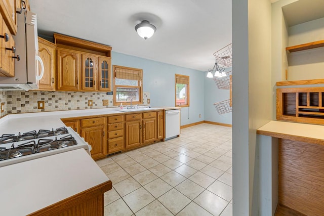 1207 Cedar Ave, Owatonna, MN 55060 - kitchen with dishwasher, a sink, a chandelier, and light countertops