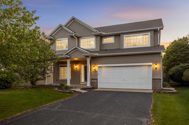 10935 Eagle View Pl, Woodbury, MN 55129 - view of front facade with an attached garage, asphalt driveway, covered porch, a front lawn, and brick siding