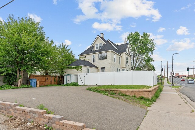 2744 Stevens Ave, Minneapolis, MN 55408 - view of property exterior featuring a chimney and a shingled roof