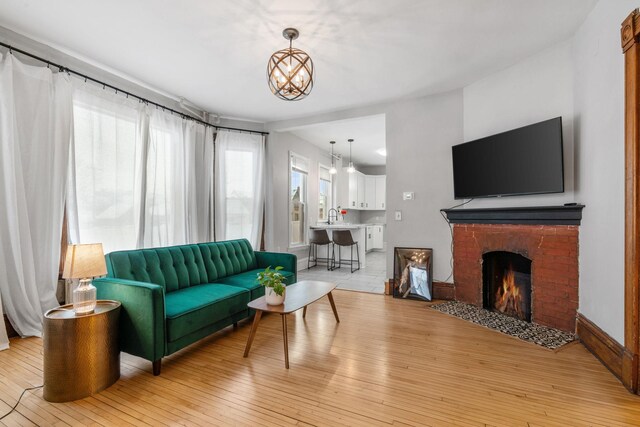 2744 Stevens Ave, Minneapolis, MN 55408 - living area featuring light wood finished floors and a fireplace