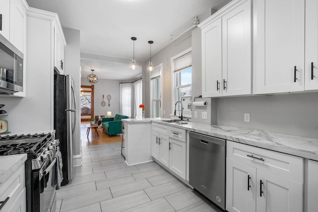 2744 Stevens Ave, Minneapolis, MN 55408 - kitchen with stainless steel appliances, a sink, white cabinets, and healthy amount of natural light
