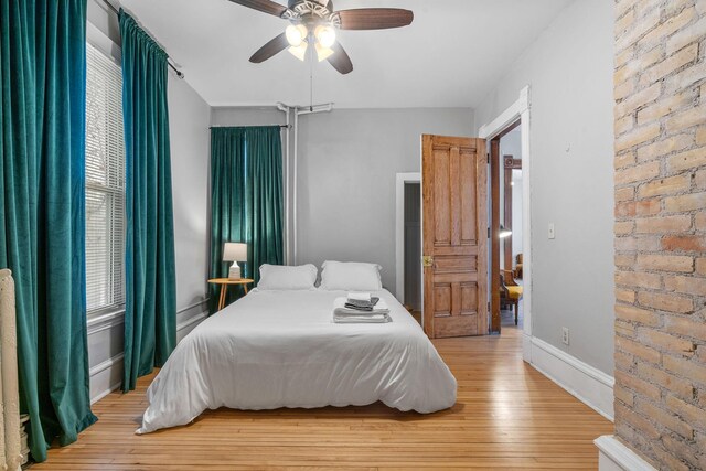 2744 Stevens Ave, Minneapolis, MN 55408 - bedroom with light wood finished floors, baseboards, and a ceiling fan