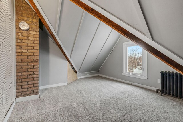 2744 Stevens Ave, Minneapolis, MN 55408 - bonus room featuring radiator, carpet flooring, baseboards, and brick wall