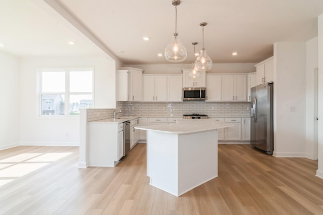 4623 Obsidian Way, Victoria, MN 55386 - kitchen with stainless steel appliances, backsplash, light countertops, light wood-style flooring, and recessed lighting
