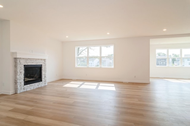 4623 Obsidian Way, Victoria, MN 55386 - unfurnished living room with plenty of natural light, light wood-style flooring, a fireplace, recessed lighting, and baseboards