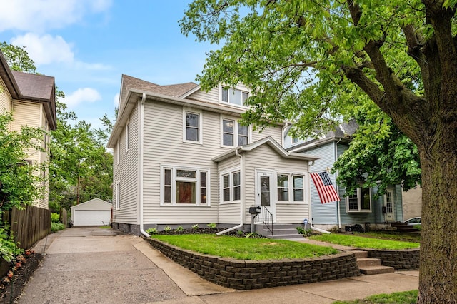 658 Plum St, Saint Paul, MN 55106 - traditional style home with a garage, an outdoor structure, a front lawn, and entry steps