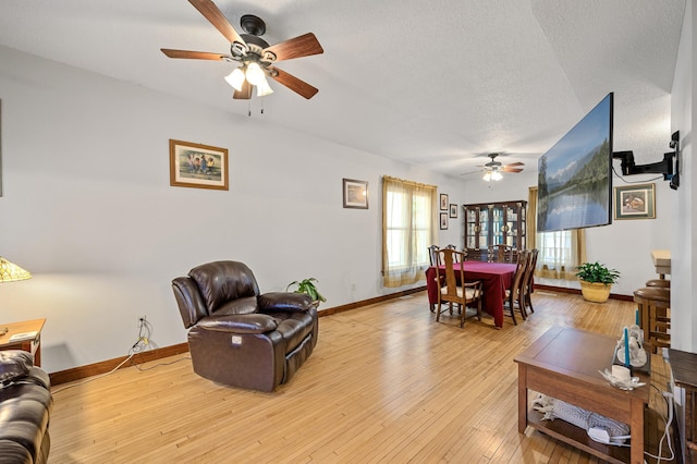 658 Plum St, Saint Paul, MN 55106 - living area featuring a ceiling fan, baseboards, light wood finished floors, and a textured ceiling