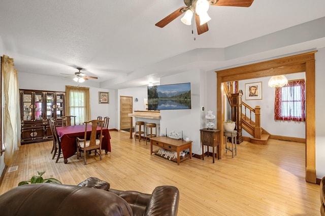 658 Plum St, Saint Paul, MN 55106 - living area with a ceiling fan, light wood-style floors, stairway, and baseboards
