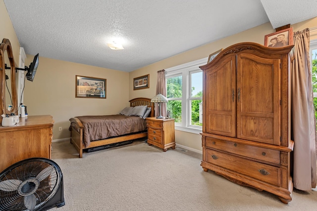 658 Plum St, Saint Paul, MN 55106 - bedroom with baseboards, a textured ceiling, and light colored carpet