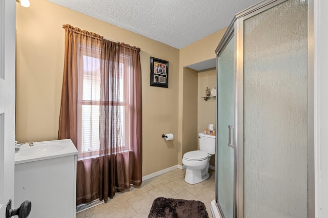658 Plum St, Saint Paul, MN 55106 - full bathroom featuring vanity, toilet, a shower stall, tile patterned flooring, and a textured ceiling