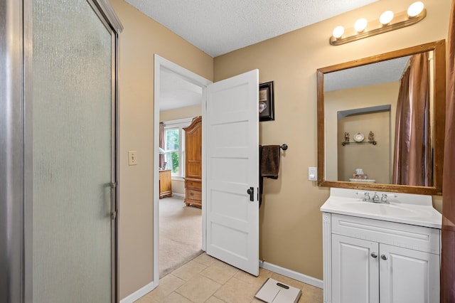 658 Plum St, Saint Paul, MN 55106 - full bathroom featuring vanity, baseboards, a stall shower, a textured ceiling, and tile patterned floors