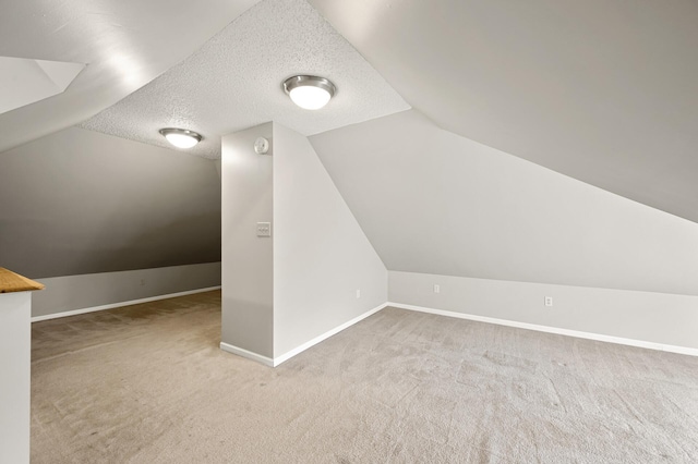 658 Plum St, Saint Paul, MN 55106 - bonus room with vaulted ceiling, carpet floors, baseboards, and a textured ceiling