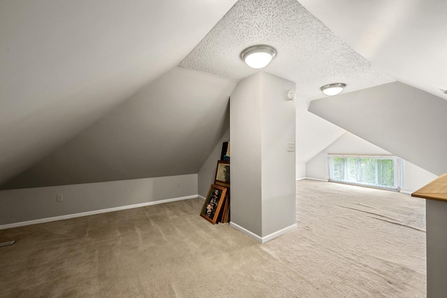 658 Plum St, Saint Paul, MN 55106 - bonus room featuring carpet flooring, baseboards, vaulted ceiling, and a textured ceiling
