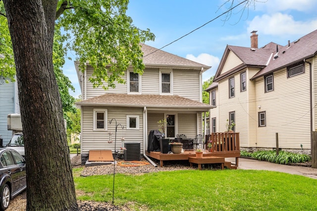 658 Plum St, Saint Paul, MN 55106 - back of house featuring a lawn, a wooden deck, cooling unit, and a shingled roof