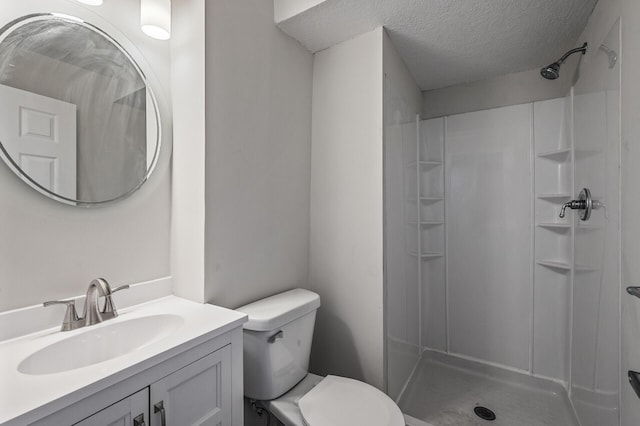 full bath featuring a textured ceiling, toilet, a shower, and vanity