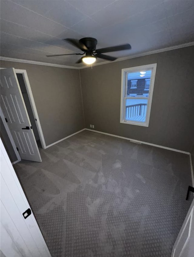 unfurnished bedroom with carpet flooring, crown molding, baseboards, and ceiling fan