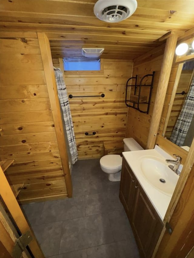 full bath featuring wood walls, toilet, vanity, and wood ceiling