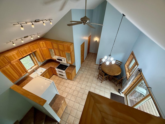 5502 Mallard Ln NE, Bemidji, MN 56601 - kitchen featuring white appliances, light tile patterned floors, high vaulted ceiling, a ceiling fan, and rail lighting