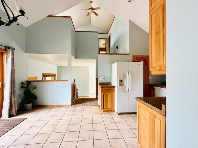 5502 Mallard Ln NE, Bemidji, MN 56601 - kitchen with white fridge with ice dispenser, high vaulted ceiling, dark countertops, ceiling fan, and light tile patterned floors